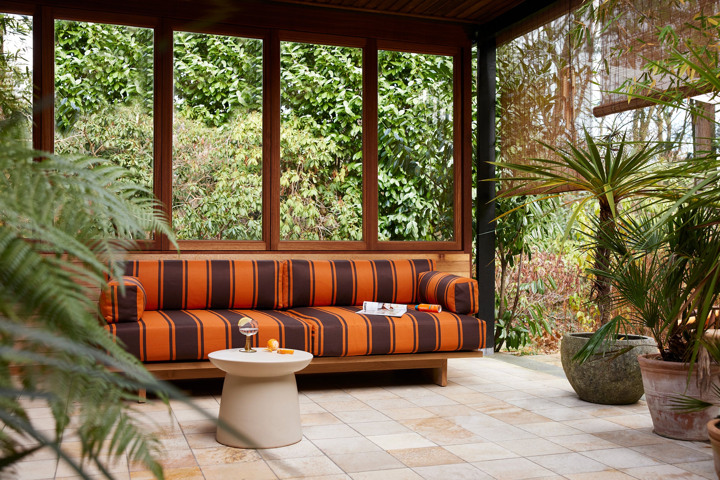 Style room setting with orange and brown sofa